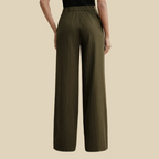 A person wearing olive green pinstriped wide-leg pants.