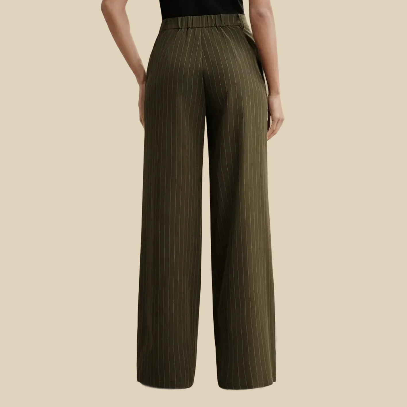 A person wearing olive green pinstriped wide-leg pants.