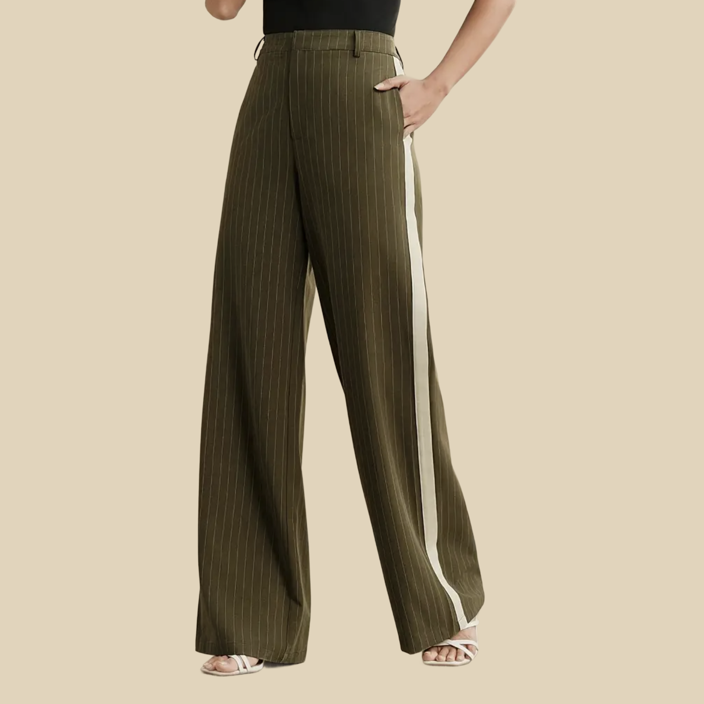 A person wearing olive green pinstriped wide-leg pants with a white stripe down the side.